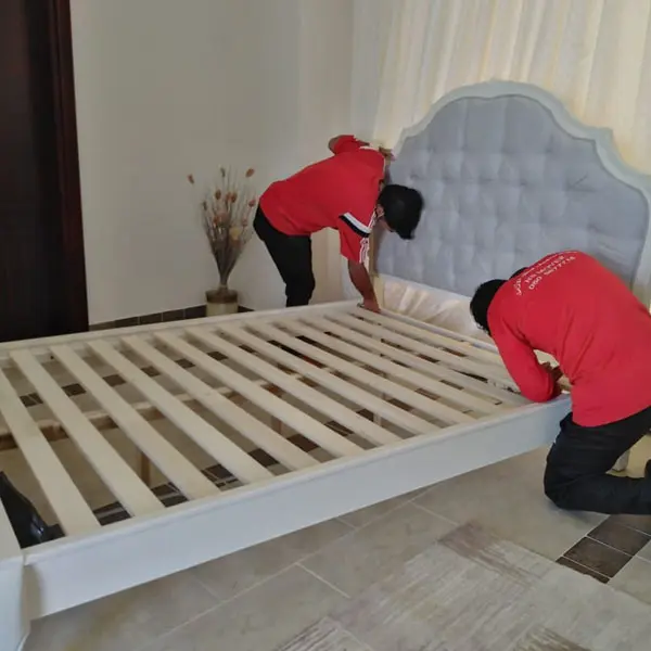 Movers and packers in Abu Dhabi disassembling furniture